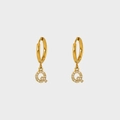 Detailed macro of gold plated stainless steel earring with pavé zircon letter Q charm - Letter Q