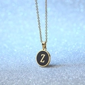 Golden round pendant necklace with black enamel inlay and letter Z on blue background - Letter Z