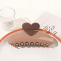 Detailed view of a sleek brown heart hair claw clip on a stylish decorative tray - Heart Semicircle / Coffee
