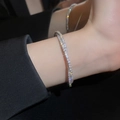 Close-up of luxury double-row zircon pavé bracelet in silver on woman's wrist - Silver Double Layer