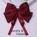 Deep red satin hair clip with large bow and long ribbons on lavender background - Burgundy