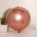 Rose gold round foil balloon in a cozy domestic interior setting for celebrations - 4D Sphere Rose Gold / 22 Inch