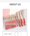 Close-up of 12-piece makeup brush set with orange handles and soft grey bristles - Holiday 12Pcs + Gift Box