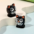 Detailed close-up of two miniature owl resin charms for DIY jewelry and micro landscapes - Owl