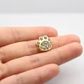 Close-up of a golden cat paw charm with sparkling rhinestones for DIY accessories - 10MM Gold Rhinestone-Paw Print