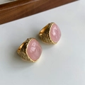 Detailed view of two gold metal rings with pink crystal cabochons and textured band - US 7 / Pink Crystal