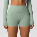 Close-up of high-waisted seamless yoga shorts in mint green with elastic fabric detail - 7101 Shorts - Basil Green / S