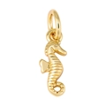 Macro detail of golden seahorse pendant with sparkling cubic zirconia and glossy finish - Seahorse