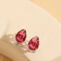 Elegant silver drop earrings featuring faceted red pear-cut crystals on a stone surface - Red (Silver)