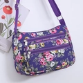 Purple floral crossbody bag with multiple zippers for organized outdoor travel storage - Purple