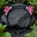 Macro view of pink crystal cat ear headband handcrafted on a dark grey natural rock - Rose Red Cat Ears