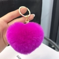 Close-up of a soft purple heart-shaped plush keychain with a polished gold metal ring - Rose Red