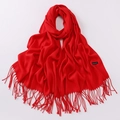 Vibrant red cashmere scarf for women with elegant tassel trim on a clean white background - Red