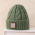 Close-up of grass green cable knit beanie featuring a cute Lucky bear patch detail - 3-8 Years / Green