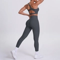 Detail view of dark grey one-shoulder sports bra and high-waisted yoga leggings - Graphite Grey