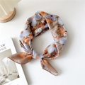 Floral cotton linen scarf in blue and orange prints tied in a stylish knot - 19 Cotton - Xanthoceras Camel