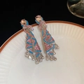 Detail of pink crystal tassel earrings with blue rhinestone fringes on a white ceramic plate - Pink Blue Rhinestone Tassel