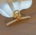 Close-up of golden metal hair claw with elegant white pearls and floral decoration - Flower Pearl Claw