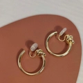 Elegant gold-tone knot design geometric clip-on earrings with clear silicone pads - Gold Knot Hoop Ear Clip
