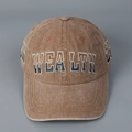 Close-up of vintage washed brown baseball cap with WEALTH embroidery and cotton texture - L (58-61cm) / Orange