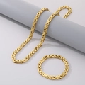 Set collana e bracciale a catena bizantina dorata esposti su un supporto grigio - Bracciale 6mm (21cm) / Oro