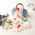 Floral print chiffon scarf with red flowers tied on a light blue leather handbag - Rose Beige