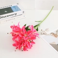 Artificial lily with three heads in vibrant magenta color on a white desk - Rose Red