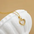 Elegant gold titanium steel heart necklace with zircon inlay on white textured display stand - No. 3 N0110 Gold