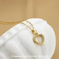 Elegant gold titanium steel heart necklace with zircon inlay on white textured display stand - No. 3 N0110 Gold