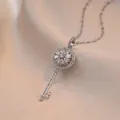 Rotating floral key pendant necklace with sparkling zircons in polished silver finish - X0411 Steel Large Rotating