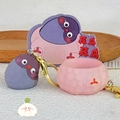 Creative purple garlic bird cartoon keychain with gold clasp on soft wooden background - Garlic Bird