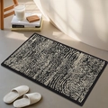 Modern thick chenille bath mat with black and white spiral pattern and woven texture - Ring Dream