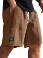 Close-up of brown knit shorts featuring 3D diamond jacquard texture and side label - Dark Brown
