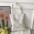 Minimalist white Oxford cloth tote bag with cartoon cloud graphics in a lifestyle setting - White with Hi Dog Print