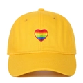 Close-up of rainbow heart embroidery on yellow cotton twill baseball cap fabric - Yellow