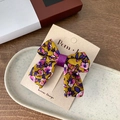 Floral print bow hair clip in mustard yellow with pink flowers on display card - Single Bow Style / Purple Bow Hair Clip