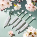 Detailed view of silver beaded pens with full rhinestones and cherry blossom accents - White