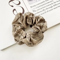 Chic snake skin pattern scrunchie hair tie in beige and brown colors on a book - Beige Brown Snake Skin