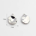 Detail view of 15mm by 11mm silver irregular oval star charms for DIY jewelry making - Oval/Organic Shape / Silver