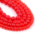 Macro view of matte red round chalcedony beads with fine textured surface for jewelry DIY - Czech Moldavite Style Red