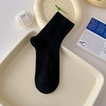 Classic black mid-calf cotton socks with a premium ribbed texture in a lifestyle setting - One Size / Black