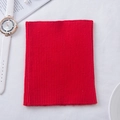 Vibrant red cashmere knit neck warmer scarf with elastic ribbed texture in flat lay view - Red