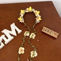 Floral hairband with yellow pear, pastel blossoms, and long dangling leaf tassels - Little Pear with Ribbon