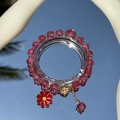 Handmade beaded bracelet with pink crackle beads and a red flower charm on mirror surface - S060 - Pink Beaded Bracelet With Bright Red Daisies #sz534