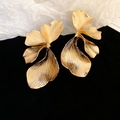 Detailed view of large golden ginkgo leaf earrings with brushed metal texture - Gold