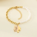 Detail of gold chain and pearl bracelet with a mother and child heart pendant - Mother And Child Embrace Silhouette (KB203712-Z)