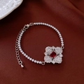 Macro view of silver floral necklace with red square gemstone and white zircon stones - Bracelet - Silver