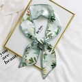 Floral print green silk hair ribbon tied in a bow on a white textured background - 7*100cm / Green Leaf Border