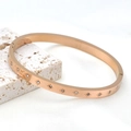 Elegant rose gold stainless steel bangle with engraved star patterns and cubic zirconia stones - Hexagram / Rose Gold