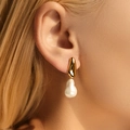 Baroque pearl earrings with irregular gold plating on a model showing elegant style - 18K Gold / Irregular Metal Baroque Style (KE1386-2)